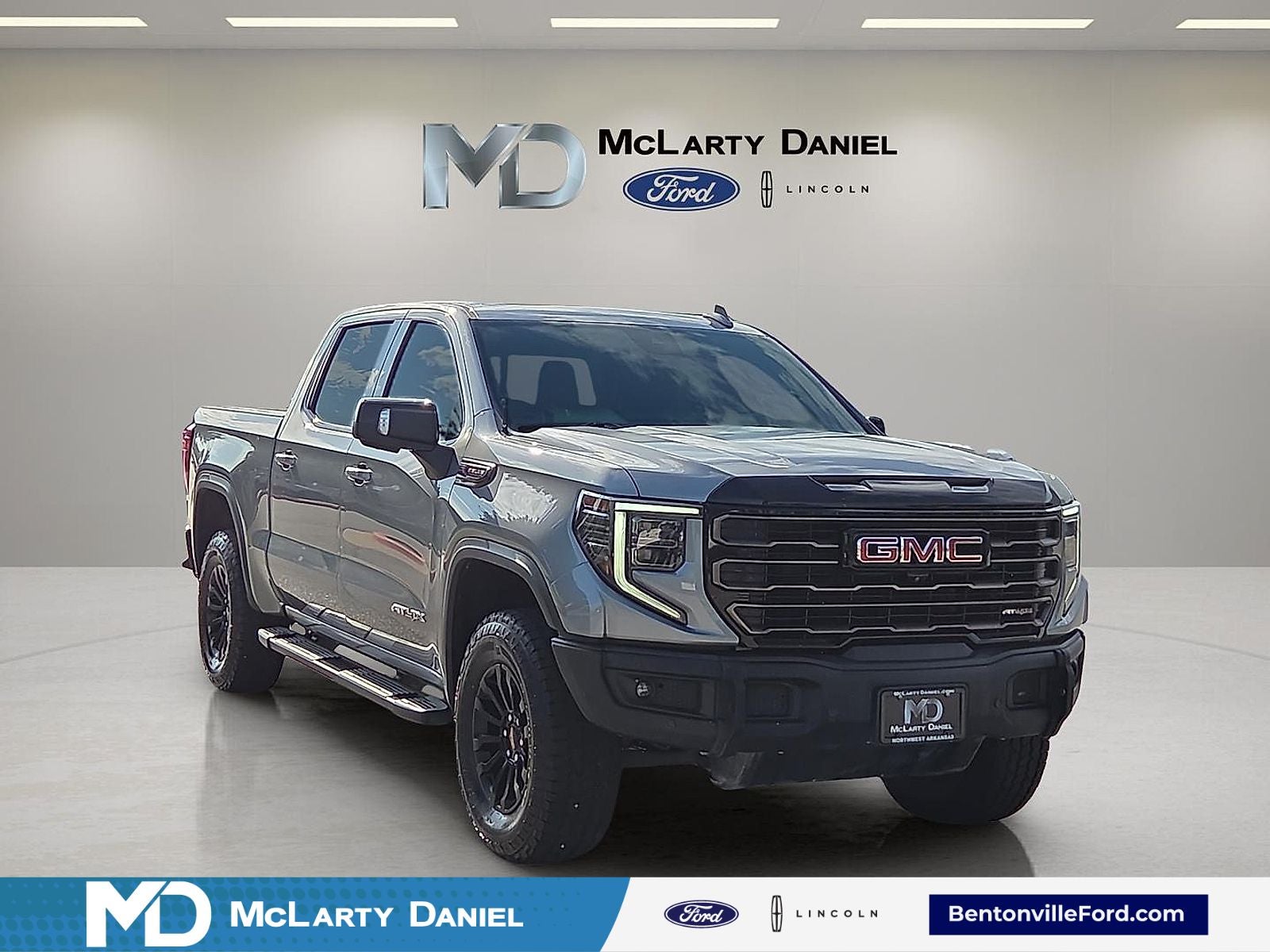 2023 GMC Sierra 1500 AT4X in Sterling Metallic — front three-quarter view